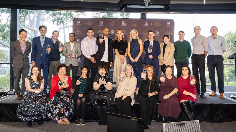 Annual Excellence Awards winners on stage presenting their trophies