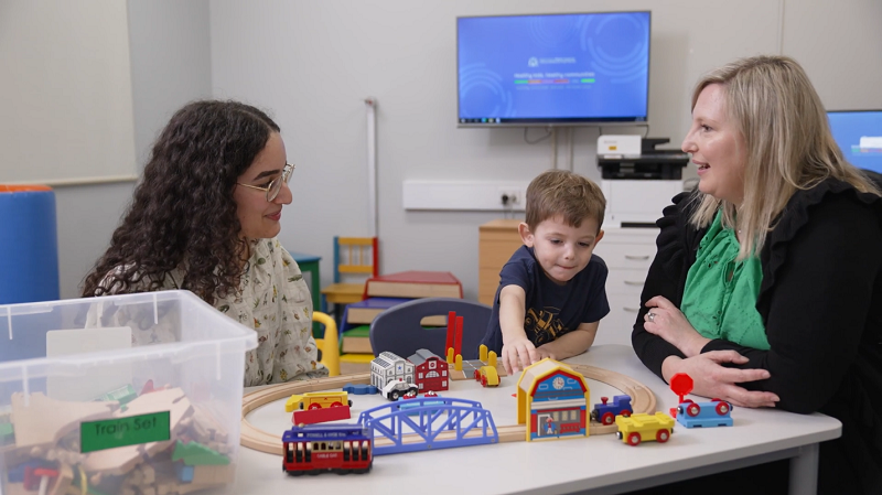 A speech pathologist working with a child and parent at the Child Development Service
