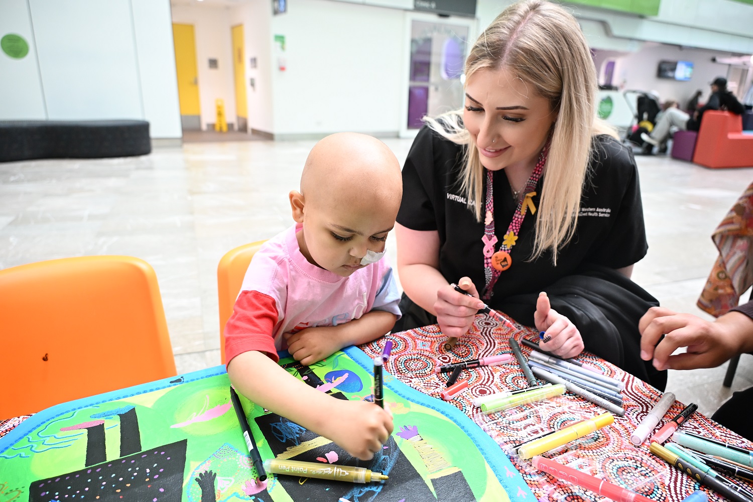 PCH patient Namirah takes part in colouring in activities for Children's Day