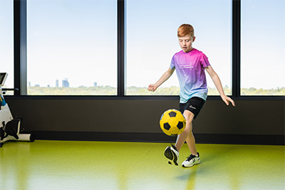 Boy kicking soccer ball